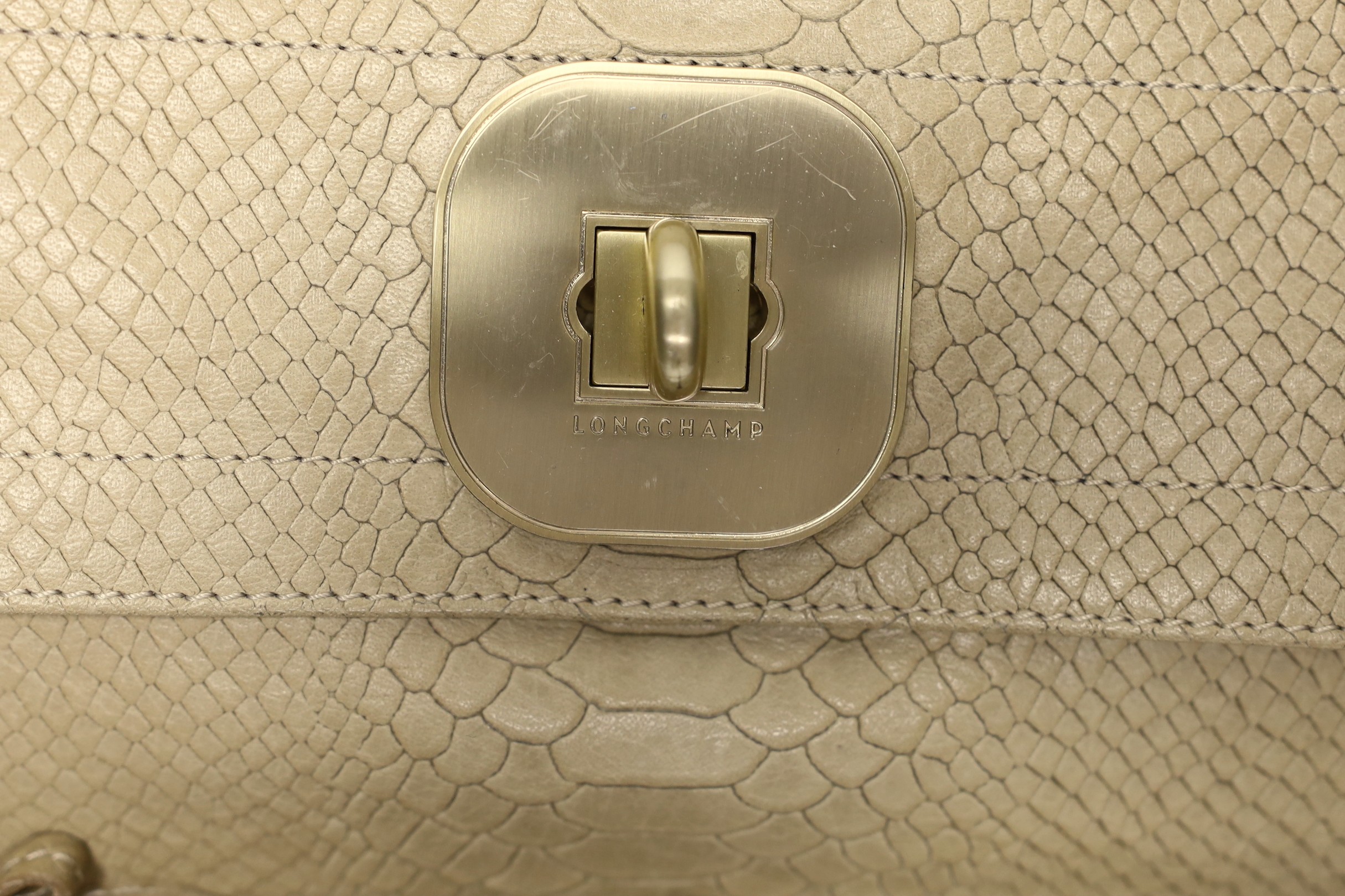 A buffalo tan leather Longchamp Women’s bag, together with a white leather Salvatore Ferragamo Women's shoulder bag. Both with original dust bags